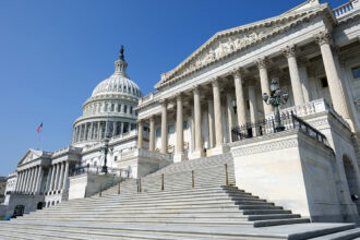 A forced perspective photo of the back of the U.S. Capitol, taken from down low so the building looms.