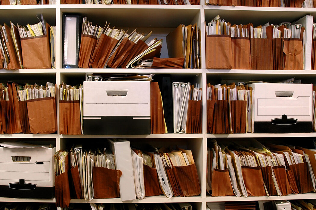 Office shelves full of files and paper boxes.