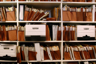 Office shelves full of files and paper boxes.