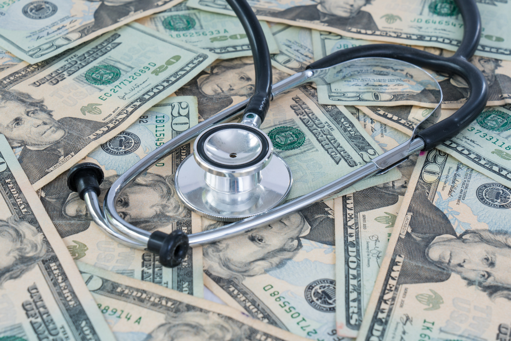 A stethoscope on a pile of money